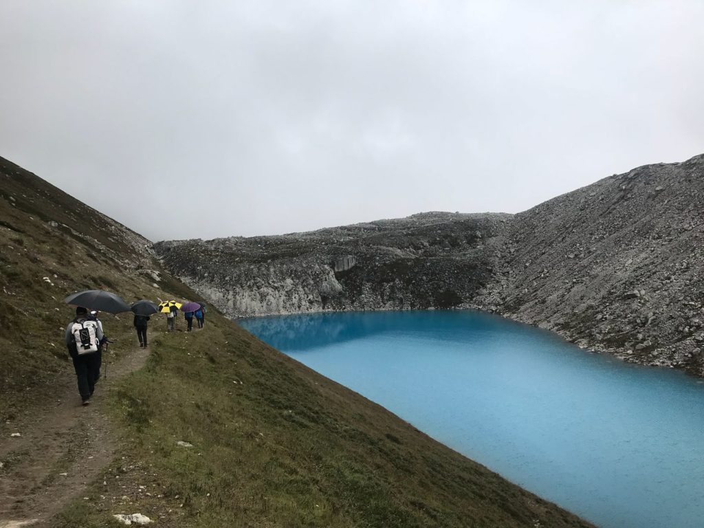 Trekking past a glacial tarn below Larkya La Pass - Photo @Pasanguide